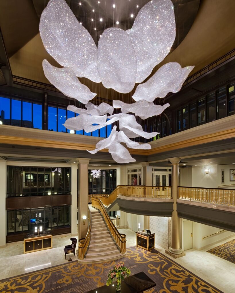Large crystalline lighting installation suspended within a hospitality atrium